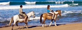 Horseback riders at Las Marias beach in Rincon Puerto Rico