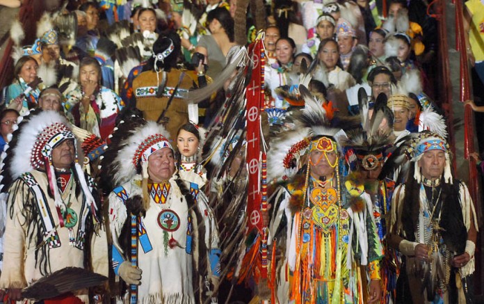 Dancers from tribal nations begin to enter the arena Friday, April 28, 2006, in Albuquerque, N.M., for the beginning of the 2006 Gathering of Nations Pow Wow. (AP Photo/Albuquerque Journal, Roberto E. Rosales)