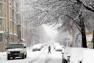 A pedestrian walks through a snow storm in New York